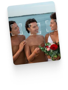 Bridesmaids holding bouquets by the water, faces detected for automatic photo delivery